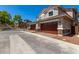 Spacious three-car garage with attractive wood doors, enhancing the exterior of the home at 2888 N Evergreen St, Buckeye, AZ 85396