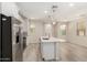 Open kitchen with stainless steel appliances, a center island, and wood-look flooring at 2888 N Evergreen St, Buckeye, AZ 85396