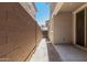 Narrow side yard featuring block wall and gated access to the home's back patio at 2888 N Evergreen St, Buckeye, AZ 85396