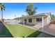 Spacious backyard features pool, covered patio, and low-maintenance landscaping at 2409 E Hampton Ave, Mesa, AZ 85204