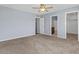 Neutral bedroom with carpet, ceiling fan, and doorways to the bathroom and closet at 2409 E Hampton Ave, Mesa, AZ 85204
