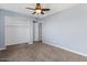 Neutral bedroom with carpet, ceiling fan, and walk-in closet with shelves at 2409 E Hampton Ave, Mesa, AZ 85204
