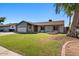 Charming single-story home with a well-maintained lawn and mature tree in a residential neighborhood at 2409 E Hampton Ave, Mesa, AZ 85204
