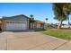 Inviting home with a spacious driveway, two-car garage, and manicured lawn in a quiet neighborhood at 2409 E Hampton Ave, Mesa, AZ 85204