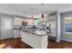 Stylish kitchen featuring granite countertops, stainless steel appliances, a center island, and ample cabinet space at 2409 E Hampton Ave, Mesa, AZ 85204