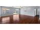 Bright living room with sleek wood flooring, sliding glass doors to the backyard pool, and neutral wall paint at 2409 E Hampton Ave, Mesa, AZ 85204