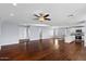 Spacious living room with hardwood floors, open to the kitchen featuring an island and modern appliances at 2409 E Hampton Ave, Mesa, AZ 85204