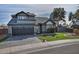 Two-story house with gray exterior, dark garage door, and landscaped yard at 5521 W Butler Dr, Chandler, AZ 85226