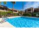 Sparkling blue swimming pool with ladders and surrounding fence at 5995 N 78Th St # 1026, Scottsdale, AZ 85250