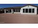 Exterior view of the backyard of a home featuring neutral walls, and a covered patio area at 12315 W Parkway Ln, Avondale, AZ 85323