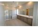 Luxurious bathroom with double vanity sinks, soaking tub, glass-enclosed shower, and contemporary design at 12315 W Parkway Ln, Avondale, AZ 85323