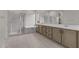 Bright bathroom with wood cabinets, dual sinks and walk-in shower and soaking tub at 12315 W Parkway Ln, Avondale, AZ 85323
