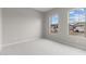 This bedroom features carpeted floors, two windows, and neutral walls at 12315 W Parkway Ln, Avondale, AZ 85323