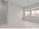 This bedroom features hardwood floors, two windows, and neutral walls at 12315 W Parkway Ln, Avondale, AZ 85323