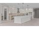 Bright kitchen featuring white cabinets, quartz counters, and stainless steel appliances at 12315 W Parkway Ln, Avondale, AZ 85323