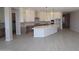 Well-appointed kitchen featuring a central island, ample storage, stainless steel appliances, and sleek countertops at 12315 W Parkway Ln, Avondale, AZ 85323