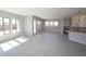 Open-concept living area featuring tile flooring, large windows, and easy access to the kitchen area at 12315 W Parkway Ln, Avondale, AZ 85323