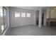 Bright living area featuring tile flooring, large windows, and a view into the kitchen area with ample natural light at 12315 W Parkway Ln, Avondale, AZ 85323