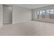 Open-concept living space with tile floors and large windows providing natural light at 12315 W Parkway Ln, Avondale, AZ 85323
