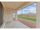 Covered patio overlooking a backyard with synthetic grass and desert landscaping; an ideal outdoor space for relaxing and entertaining at 12315 W Parkway Ln, Avondale, AZ 85323