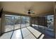 Bright sunroom with large windows and a ceiling fan overlooking a landscaped backyard at 4683 E Nightingale Ln, Gilbert, AZ 85298