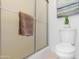 Bathroom featuring white toilet, towel rack, and artwork at 10224 E Michigan Ave, Sun Lakes, AZ 85248