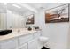 Bright bathroom featuring white cabinets, a sink, framed art, and tiled floors at 10224 E Michigan Ave, Sun Lakes, AZ 85248