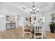 Dining room with wood look floors, nice chandelier, and easy access to the kitchen at 10224 E Michigan Ave, Sun Lakes, AZ 85248