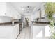 Bright kitchen with white cabinets, stainless steel appliances, and granite countertops, open to dining area at 10224 E Michigan Ave, Sun Lakes, AZ 85248