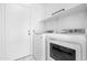 Functional laundry room with washer, dryer, and overhead shelving for storage at 10224 E Michigan Ave, Sun Lakes, AZ 85248