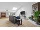 Living room features vaulted ceiling, skylight, fireplace, TV, and wood look flooring at 10224 E Michigan Ave, Sun Lakes, AZ 85248