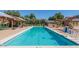 Community lap pool with shaded lounge areas for relaxing poolside at 15409 W Corrine Dr, Surprise, AZ 85379