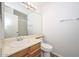 Well-lit bathroom showcases a vanity with a sink, a toilet, and a large mirror at 7977 W Wacker Rd # 174, Peoria, AZ 85381