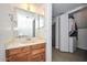 Bathroom featuring wooden cabinets and sink with access to laundry closet at 7977 W Wacker Rd # 174, Peoria, AZ 85381