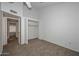 Bright bedroom featuring neutral carpeting, white walls, and a convenient closet space at 7977 W Wacker Rd # 174, Peoria, AZ 85381