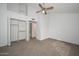 Bright bedroom featuring neutral carpeting, white walls, and a convenient closet space at 7977 W Wacker Rd # 174, Peoria, AZ 85381