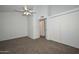Spacious carpeted bedroom with a ceiling fan and ample closet space at 7977 W Wacker Rd # 174, Peoria, AZ 85381