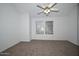 Comfortable carpeted bedroom, with a ceiling fan and sunny double window at 7977 W Wacker Rd # 174, Peoria, AZ 85381