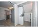 Practical laundry closet next to kitchen with stacked washer and dryer at 7977 W Wacker Rd # 174, Peoria, AZ 85381
