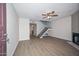 Bright living room with wood floors, ceiling fan, fireplace, and staircase to the second floor at 7977 W Wacker Rd # 174, Peoria, AZ 85381