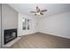 Light filled living room with wood floors, fireplace, and a white front door at 7977 W Wacker Rd # 174, Peoria, AZ 85381