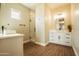 Modern bathroom boasts a glass shower, double vanity with rectangular sinks, and wood look floors at 20618 W Elliot Rd, Buckeye, AZ 85326