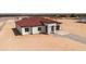 Aerial view of a single-story home featuring a red tile roof, attached garage, and neutral color scheme at 20618 W Elliot Rd, Buckeye, AZ 85326