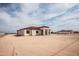 Single story home features a red tile roof, neutral exterior, and attached two car garage on a large lot at 20618 W Elliot Rd, Buckeye, AZ 85326