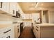 Spacious kitchen features white cabinets, quartz countertops, black hardware, and stainless steel appliances at 20618 W Elliot Rd, Buckeye, AZ 85326
