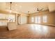 Spacious living room featuring a kitchen with an island, a ceiling fan, and french doors leading to the exterior at 20618 W Elliot Rd, Buckeye, AZ 85326