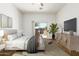 Cozy bedroom featuring a sliding glass door to the outside patio and a large screen TV at 26 S Quinn Cir # 7, Mesa, AZ 85206