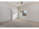 Bedroom features neutral carpet, a window overlooking a beautiful view, and a closet with sliding doors at 26 S Quinn Cir # 7, Mesa, AZ 85206