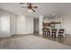 Open-concept living room featuring a breakfast bar and direct access to the kitchen with modern appliances at 26 S Quinn Cir # 7, Mesa, AZ 85206
