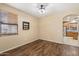 Cozy dining area with dark wood-look flooring, decorative shelving and open access to the kitchen at 1392 E Baker Dr, San Tan Valley, AZ 85140